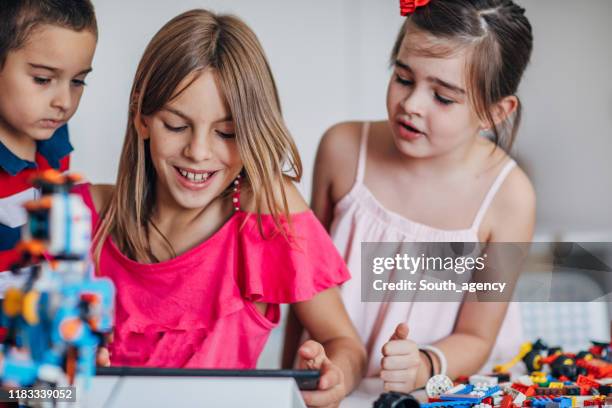 kids using digital tablet together - public school building stock pictures, royalty-free photos & images