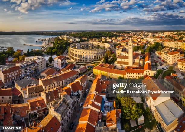 aerial drone sunset scene of pula arena amphitheatre, croatia - pula stock-fotos und bilder