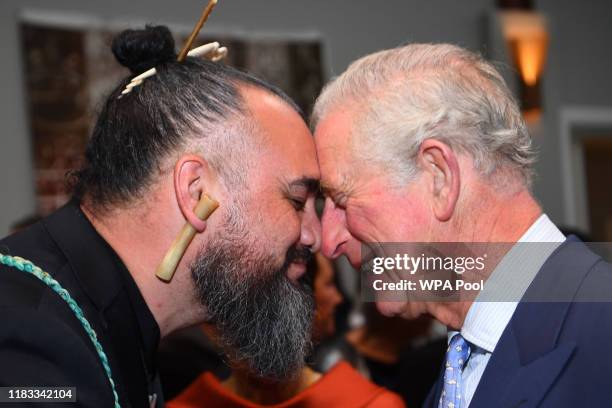 Prince Charles, Prince of Wales receives the hongi, the traditional Maori greeting, from musician Horomona Horo during a reception hosted by...