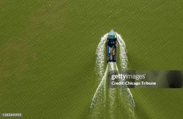 Boat of commercial fisherman Drew Koch, returns home on Sandusky Bay after fishing in Lake Erie on Sept. 27, 2019. The warm, shallow waters of Lake...