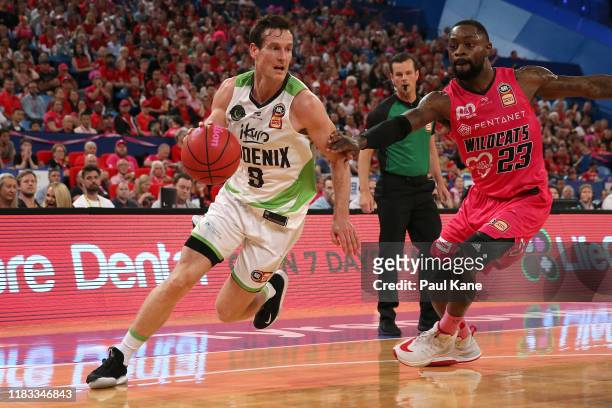 Ben Madgen of the Phoenix drives to the basket against Terrico White of the Wildcats during the round four NBL match between the Perth Wildcats and...