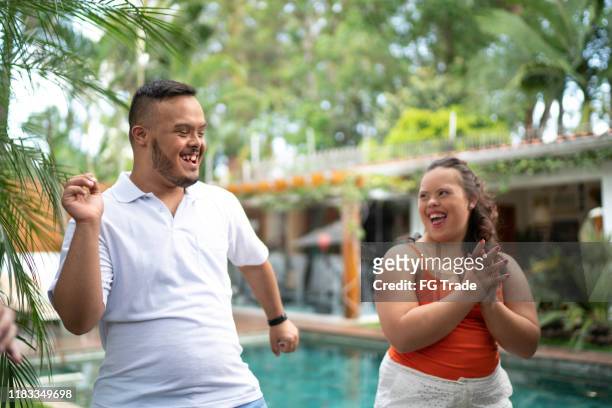 Happy special needs couple dancing in backyard