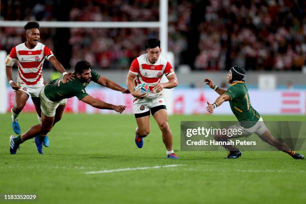 Ryoto Nakamura of Japan gets through Cheslin Kolbe of South Africa during the Rugby World Cup 2019 Quarter Final match between Japan and South Africa...