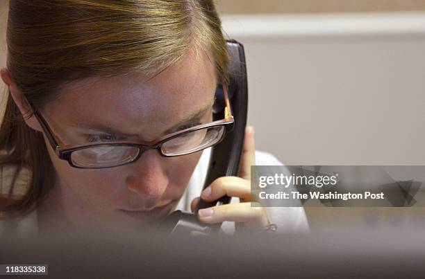 Haley Lillibridge answers the phone at CrisisLink, a suicide and crisis prevention hotline in Arlington, Va. On June 23, 2011