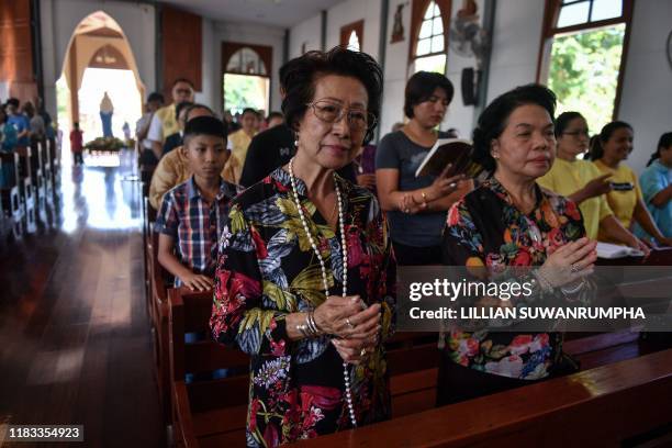This picture taken on October 26 shows Thai Catholics of Vietnamese descent praying at the Phra Mae Prachak Church in the central Thai province of...
