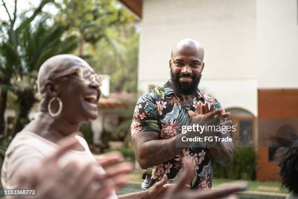 family reunited, singing in backyard - man applauding stock pictures, royalty-free photos & images