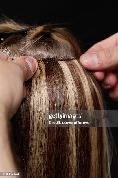 hairstylist applying hair extensions - hair extensions stock pictures, royalty-free photos & images