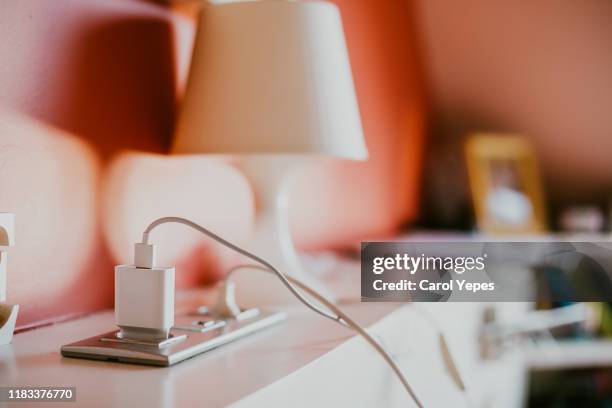 connect the charger connector to household power - enchufe fotografías e imágenes de stock