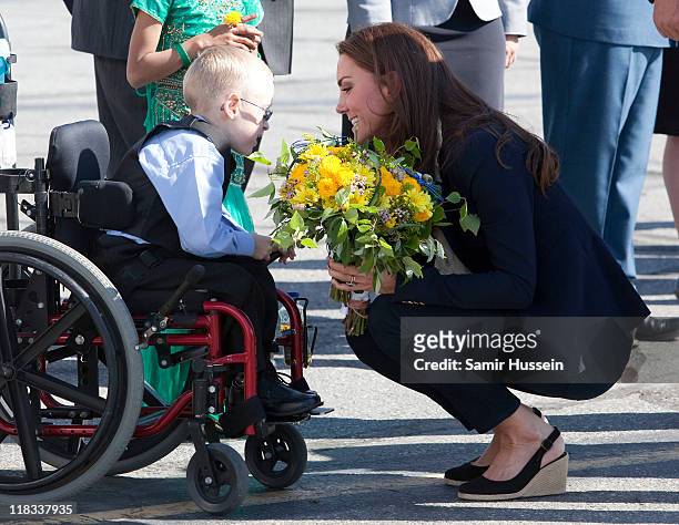 Catherine, Duchess of Cambridge meets a young boy in a wheelchair as she departs from Yellowknife airport on July 6, 2011 in Yellowknife, Canada.