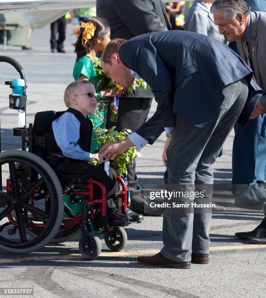 Prince William, Duke of Cambridge meets a young boy as he departs from Yellowknife airport on July 6, 2011 in Yellowknife, Canada.