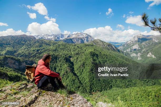 after hiking, man resting on the rock in the mountain. - alpes do allgäu imagens e fotografias de stock