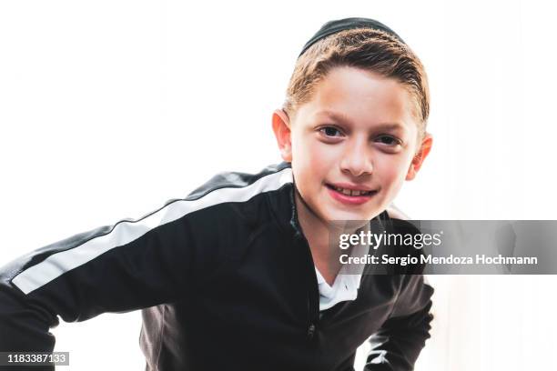 one young jewish boy looking and smiling at the camera on a white background - skull cap stock pictures, royalty-free photos & images