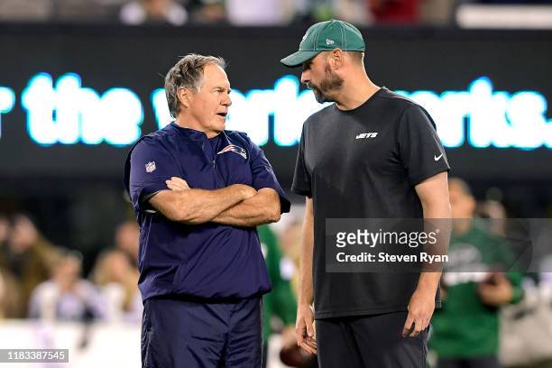 Head coach Bill Belichick of the New England Patriots and head coach Adam Gase of the New York Jets speak prior to the game at MetLife Stadium on...