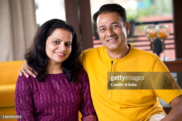 loving couple relaxing at home - indian elderly couple stock pictures, royalty-free photos & images