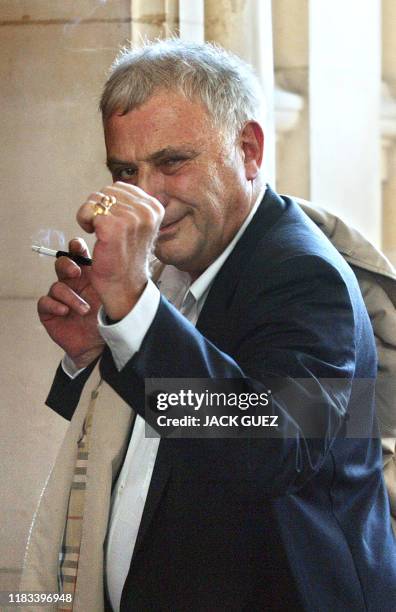 L'écrivain Philippe Sollers fait un clin d'oeil au photographe, le 17 septembre 2002 devant la 17e chambre du tribunal correctionnel de Paris, avant...