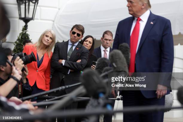 President Donald Trump speaks to members of the media as White House Senior Counselor Kellyanne Conway, Deputy Press Secretary Hogan Gidley, and...
