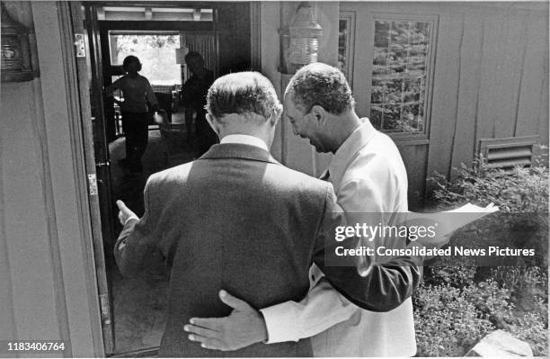 Arm in arm, Egyptian President Anwar Al Sadat and Israeli Prime Minister Menachem Begin talk during the Egyptian-Israeli peace negotiations, outside...