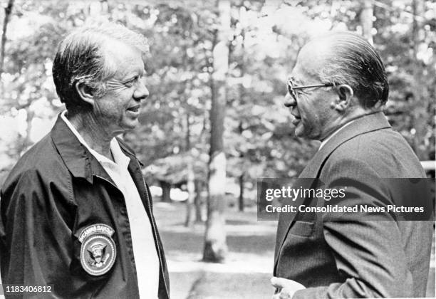 President Jimmy Carter and Israeli Prime Minister Menachem Begin talk together during the Egyptian-Israeli peace negotiations at Camp David, near...