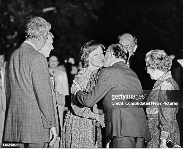 First Lady Rosalynn Carter and Israeli Prime Minister Menachem Begin share a kiss on the cheek a kiss on the South Lawn of the White House,...