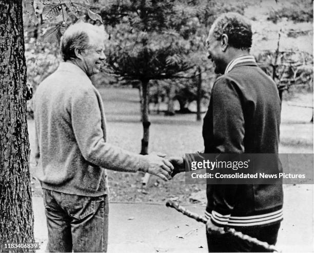 President Jimmy Carter and Egyptian President Anwar Al Sadat shake hands during the Egyptian-Israeli peace negotiations at Camp David, near Thurmont,...