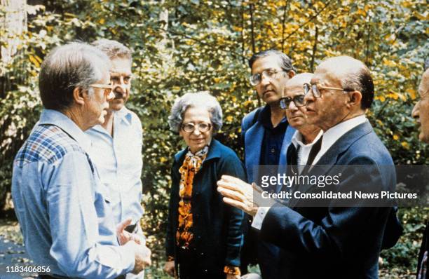 President Jimmy Carter talks with Israeli Prime Minister Menachem Begin and his party during the Egyptian-Israeli peace negotiations at Camp David,...