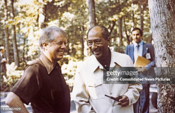 President Jimmy Carter and Egyptian President Anwar Al Sadat talk together during the Egyptian-Israeli peace negotiations at Camp David, near...