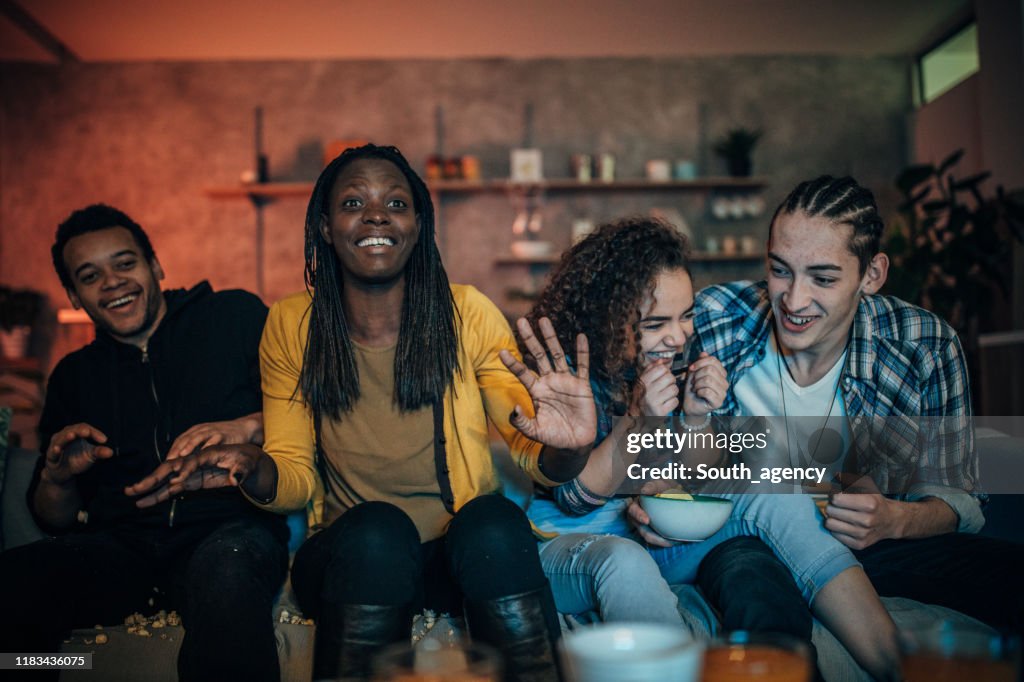 Multi-ethnic friends watching TV