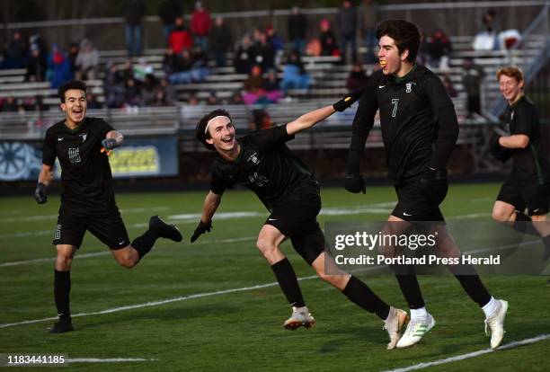 Waynflete's Patty Shaw, Joey Ansel-Mullen and Aiden Kieffer celebrate after Kieffer scored a second half goal against Mt. View in the Class C State...