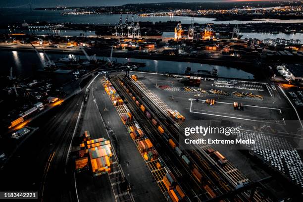 aerial view of the new jersey shipyard with numerous cranes, gantries and shipping containers, captured at golden hour - shipping stock pictures, royalty-free photos & images