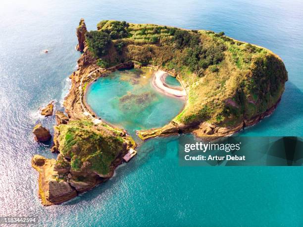 cool aerial view of circle pool inside volcanic island with eye shape in the azores islands. - island foto e immagini stock