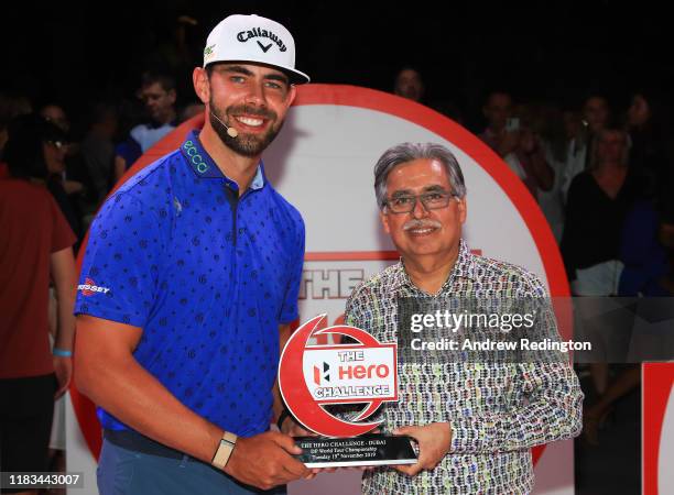 Erik Van Rooyen of South Africa poses with the trophy and Pawan Munjal, Chairman of Hero MotoCorp during the DP World Tour Championship Hero...