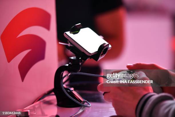 Visitor plays a cloud-game at the stand of Google Stadia during the Video games trade fair Gamescom in Cologne, western Germany, on August 21, 2019.