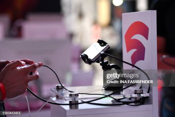 Visitor plays a cloud-game at the stand of Google Stadia during the Video games trade fair Gamescom in Cologne, western Germany, on August 21, 2019.