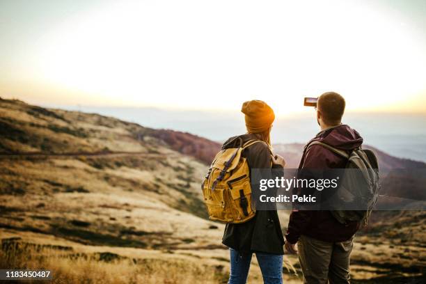 this moment needs to be remembered forever - young couple hiking stock pictures, royalty-free photos & images