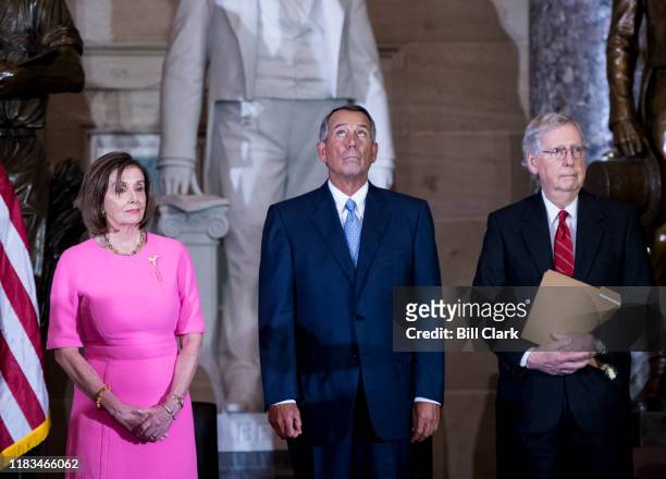 Former Speaker of the House John Boehner, R-Ohio, center, tries to hold back tears as he stands with Speaker of the House Nancy Pelosi, D-Calif., and...