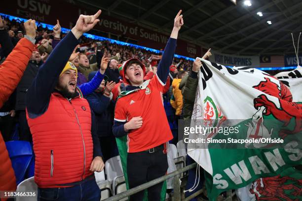 Wales fans celebrate victory and qualification after the UEFA Euro 2020 Qualifier between Wales and Hungary at Cardiff City Stadium on November 19,...