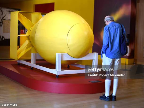 Tourist looks at a lifesize wooden replica of the 'Fat Man' atomic bomb which was dropped on Nagasaki, Japan in 1945. The replica is part of an...
