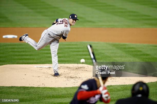 Zack Greinke of the Houston Astros delivers the pitch to Anthony Rendon of Washington Nationals during the first inning in Game Three of the 2019...