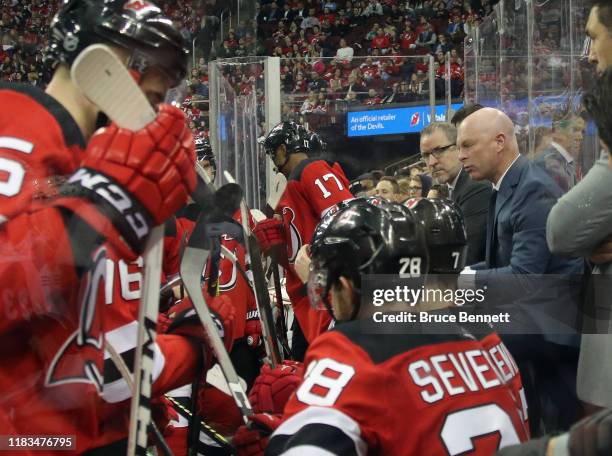 John Hynes of the New Jersey Devils tends to the bench during the second period against the Arizona Coyotes at the Prudential Center on October 25,...