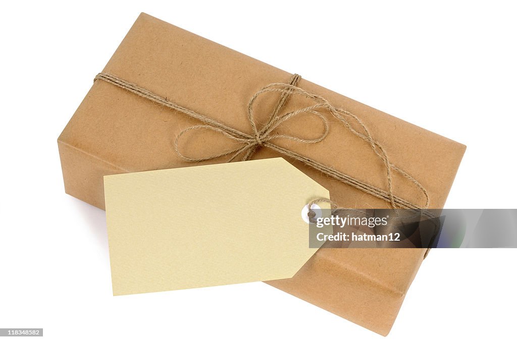 Thin brown paper package with string and tag