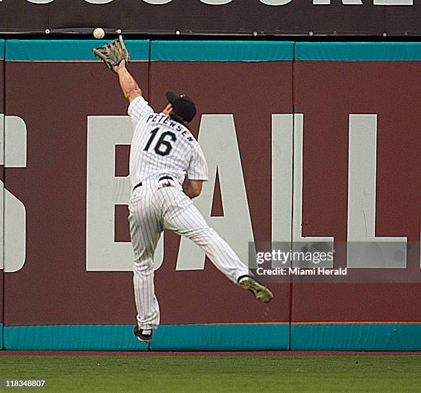 Florida Marlins center fielder Bryan Peterson missed a double by Philadelphia Phillies' Raul Ibanez in the second inning at Sun Life Stadium in Miami...