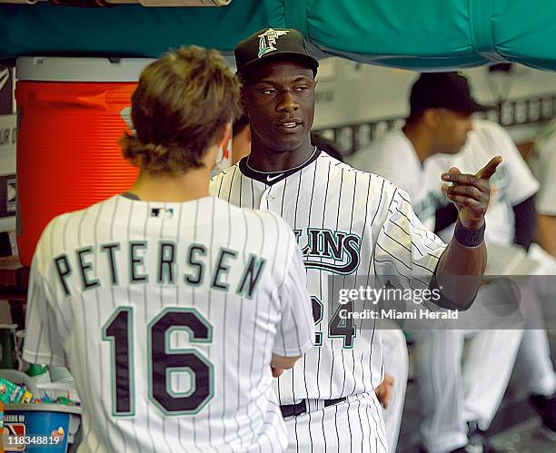 Florida Marlins newest player Mike Cameron gives some pointers to outfielder Bryan Peterson in the second inning of a MLB game against the...