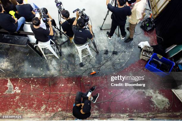 Member of the film crew looks at his mobile phone during filming at the Yeah1 Group Corp. Studio in Ho Chi Minh city, Vietnam, on Monday, March 4,...