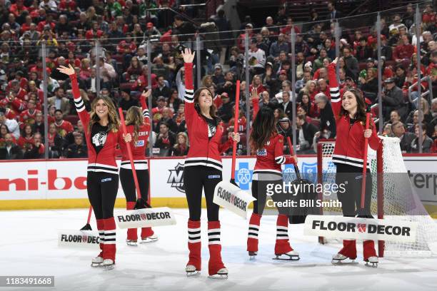 The Chicago Blackhawks ice-crew waves to fans during the game between the Chicago Blackhawks and the Carolina Hurricanes at the United Center on...