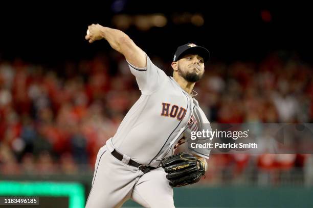 Roberto Osuna of the Houston Astros delivers the pitch against the Washington Nationals during the ninth inning in Game Three of the 2019 World...