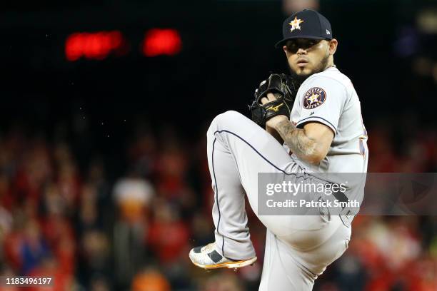 Roberto Osuna of the Houston Astros delivers the pitch against the Washington Nationals during the ninth inning in Game Three of the 2019 World...