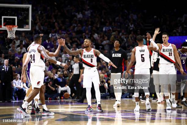 Damian Lillard of the Portland Trail Blazers congratulates teammates during a time out of their game against the Sacramento Kings at Golden 1 Center...