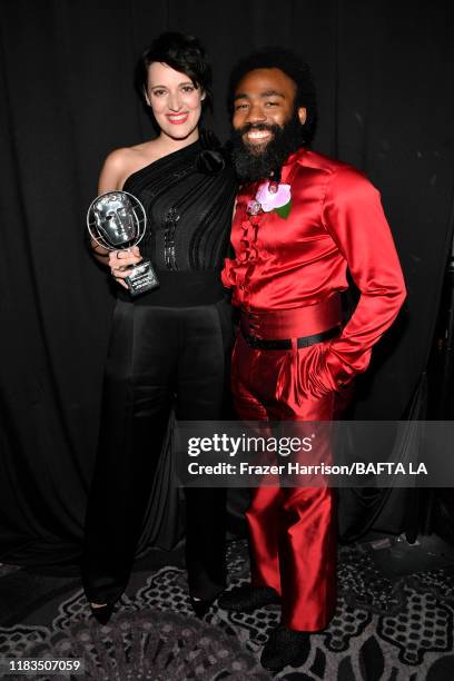 Phoebe Waller-Bridge, recipient of the Britannia Award for British Artist of the Year, and Donald Glover pose during the 2019 British Academy...