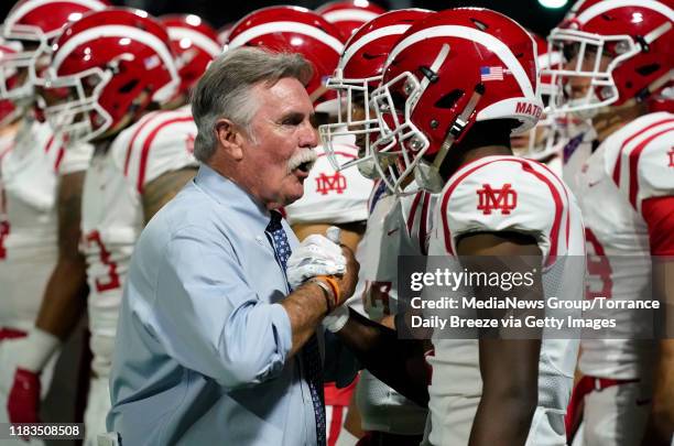 Mater Dei's head coach Bruce Rollinson talks with his players before the start of the game in Bellflower on Friday, Oct. 25, 2019.