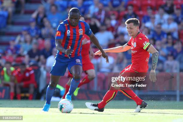 Abdiel Arroyo of the Newcastle Jets contests the ball with Michael Jakobsen of Adelaide United during the round three A-League match between the...